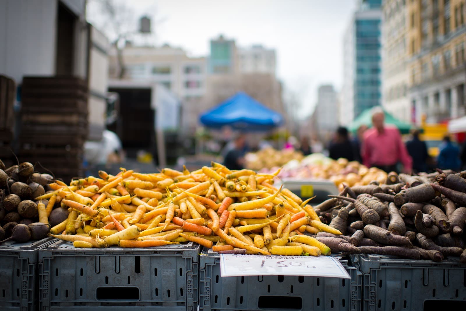 Cenouras e beterrabas frescas expostas em feira.