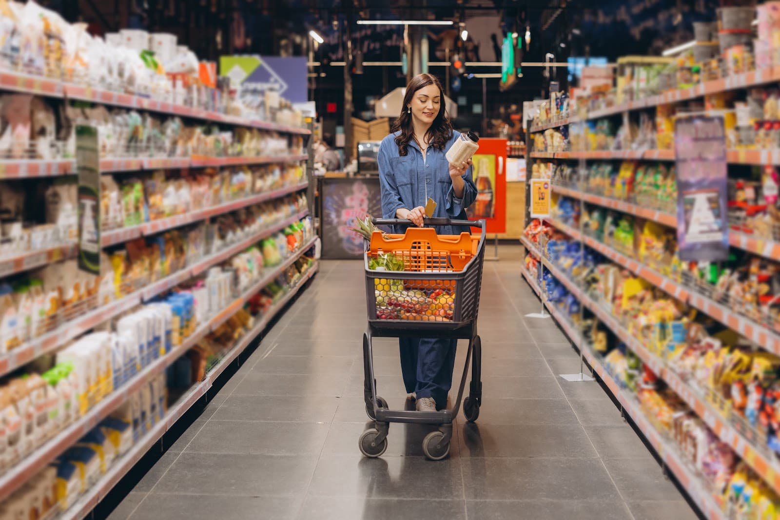 Cliente analisa rotulos de produtos em corredor de supermercado.